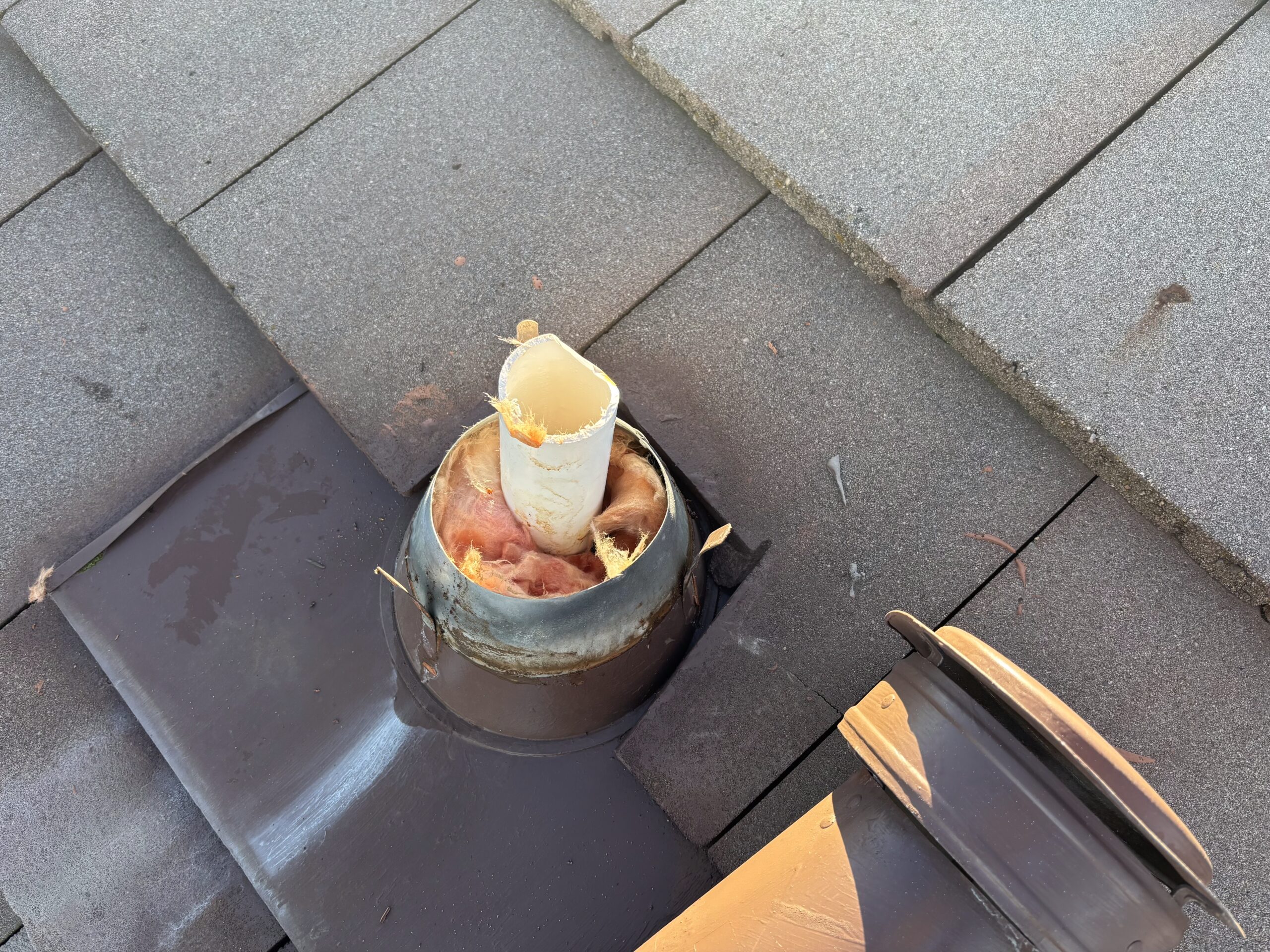 Furnace flue pipe penetrating roof during HVAC repair in Sun City Hills, Lincoln CA